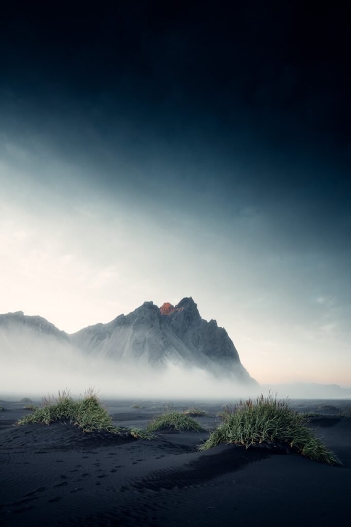 snow covered mountain under cloudy sky during daytime